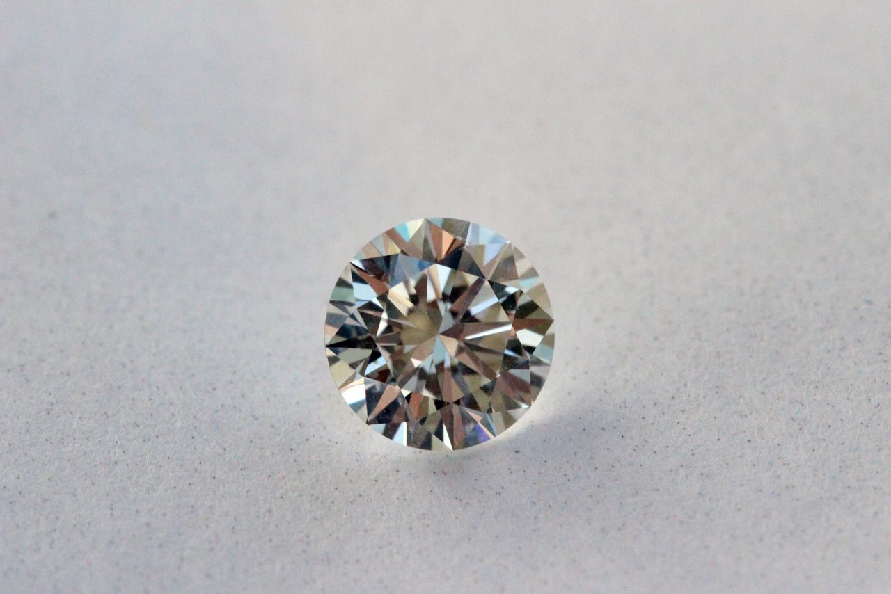 A loose round brilliant cut diamond photographed against a plain white background