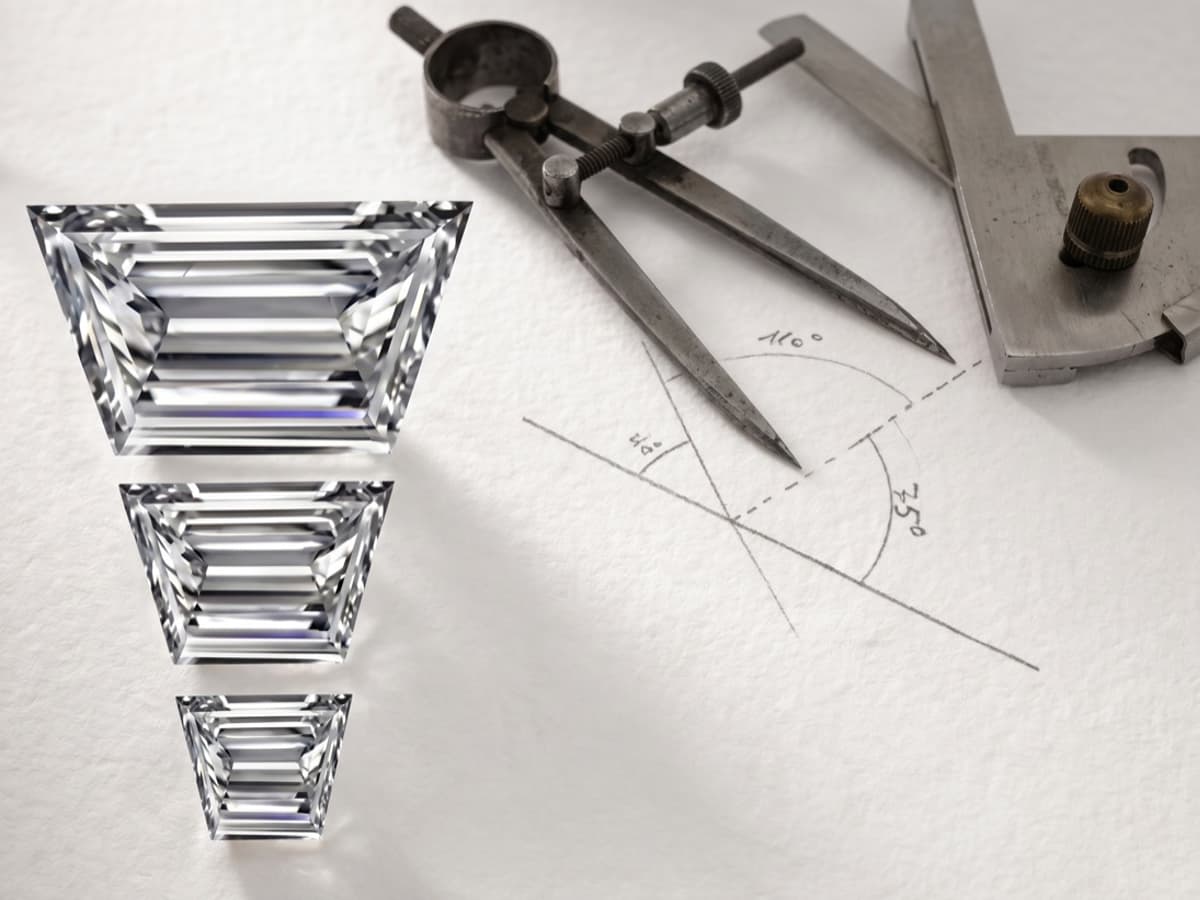 Three stepped tapered stones beside a drafting compass and a hand drawn angle